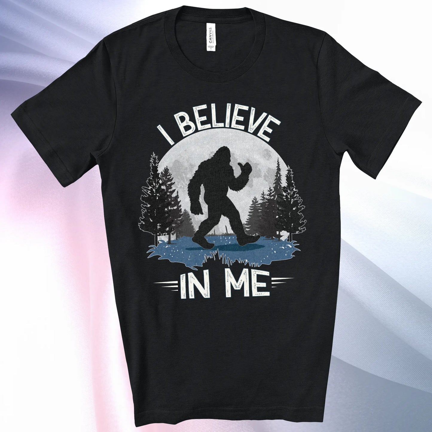 Black colored Bigfoot Believes T-Shirt with Bigfoot's silhouette in a moonlit forest and I Believe at the top and In Me below
