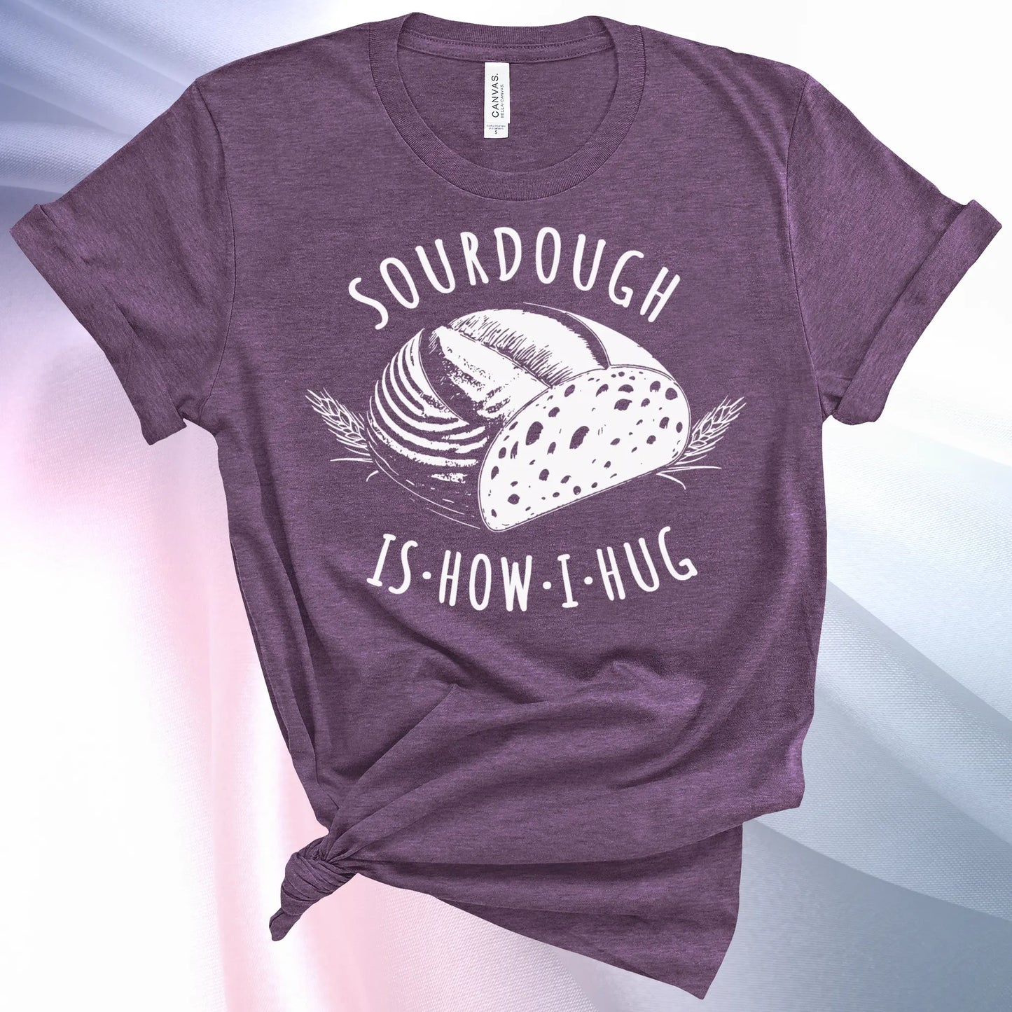 Heather Team Purple colored Sourdough Hug T-Shirt featuring a loaf of sourdough and "Sourdough" above and "Is How I Hug" below