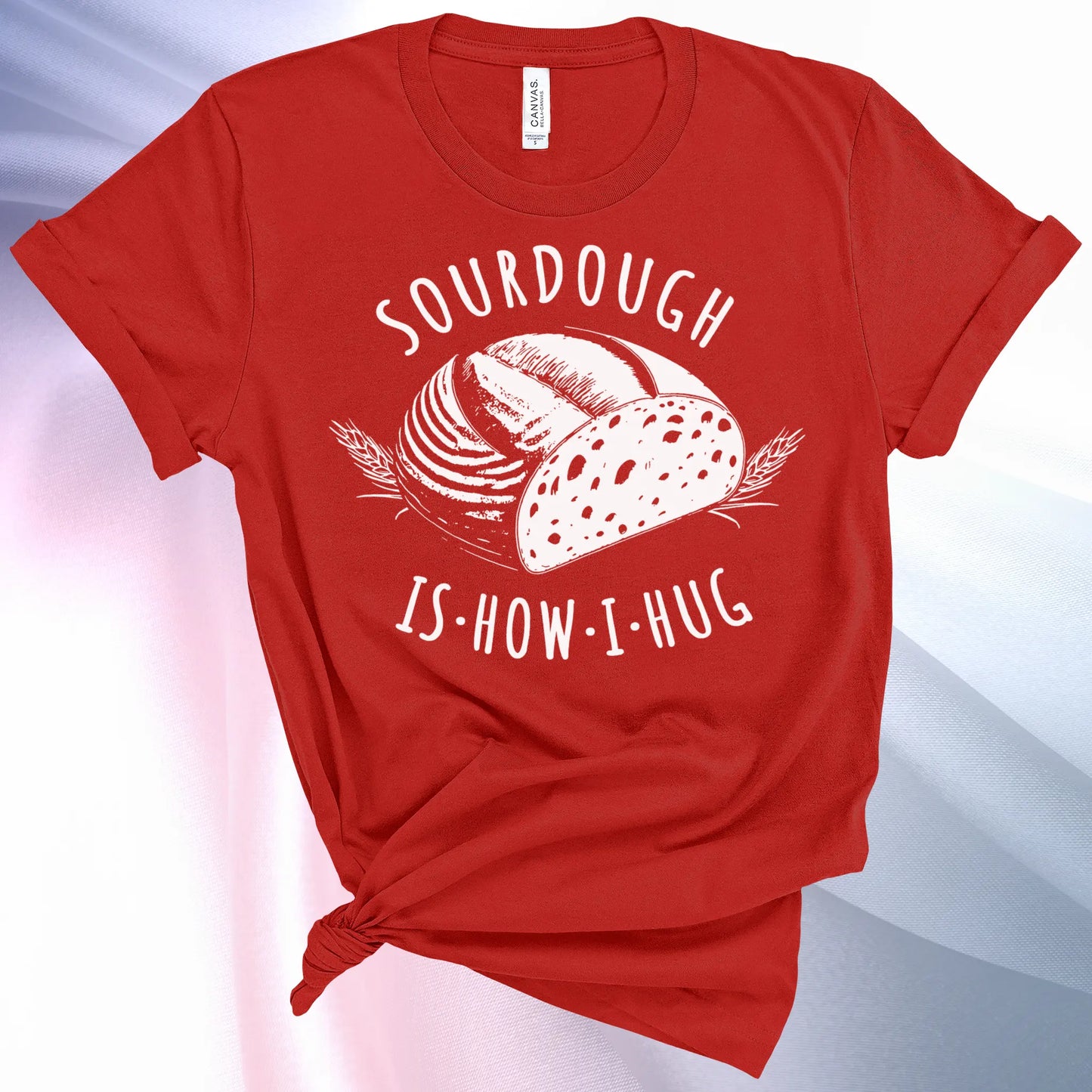 Red colored Sourdough Hug T-Shirt featuring a loaf of sourdough and "Sourdough" above and "Is How I Hug" below