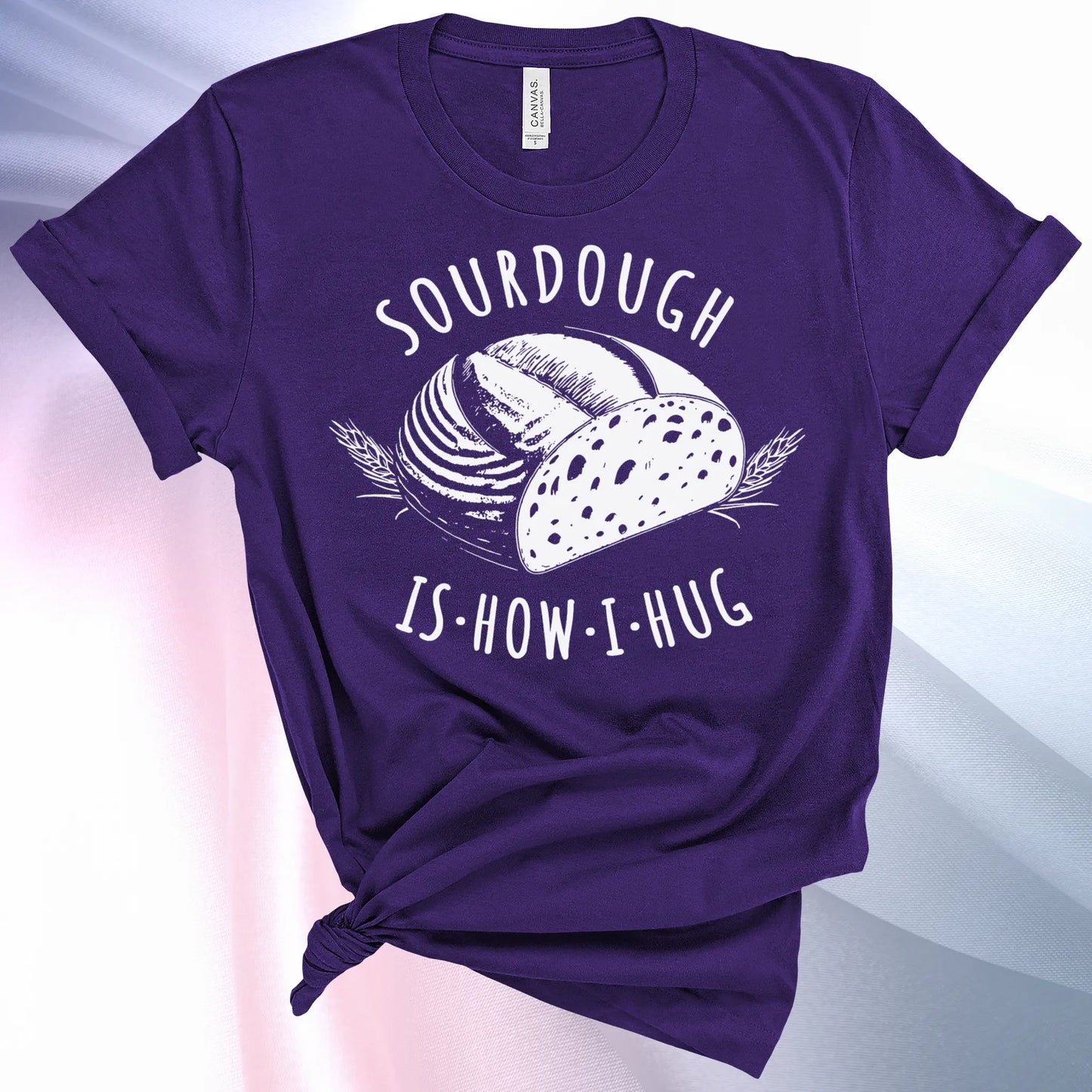 Team Purple colored Sourdough Hug T-Shirt featuring a loaf of sourdough and "Sourdough" above and "Is How I Hug" below