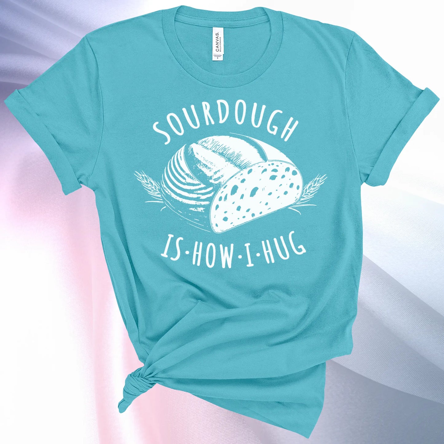 Turquoise colored Sourdough Hug T-Shirt featuring a loaf of sourdough and "Sourdough" above and "Is How I Hug" below