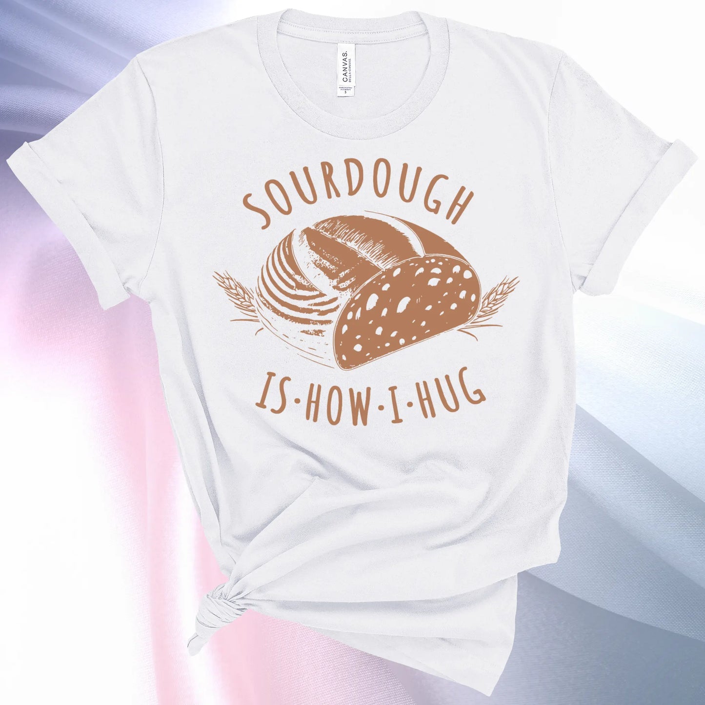 White colored Sourdough Hug T-Shirt featuring a loaf of sourdough and "Sourdough" above and "Is How I Hug" below